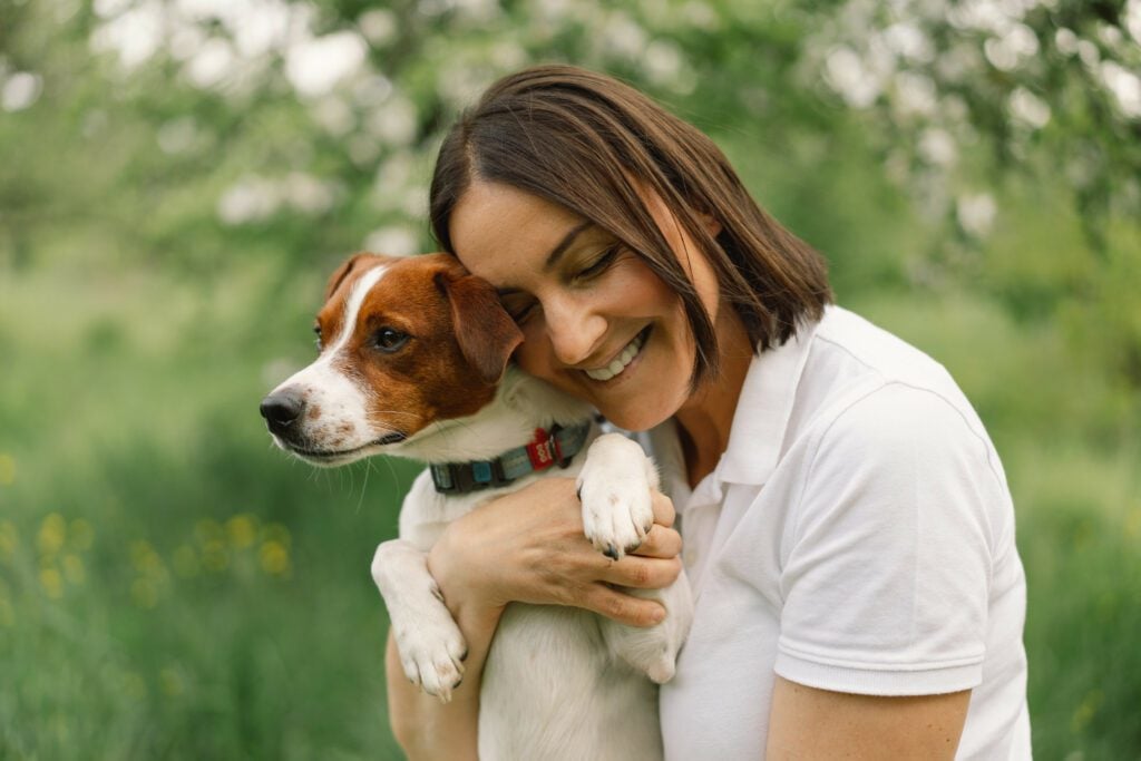 A woman in a park with her service dog for ADHD