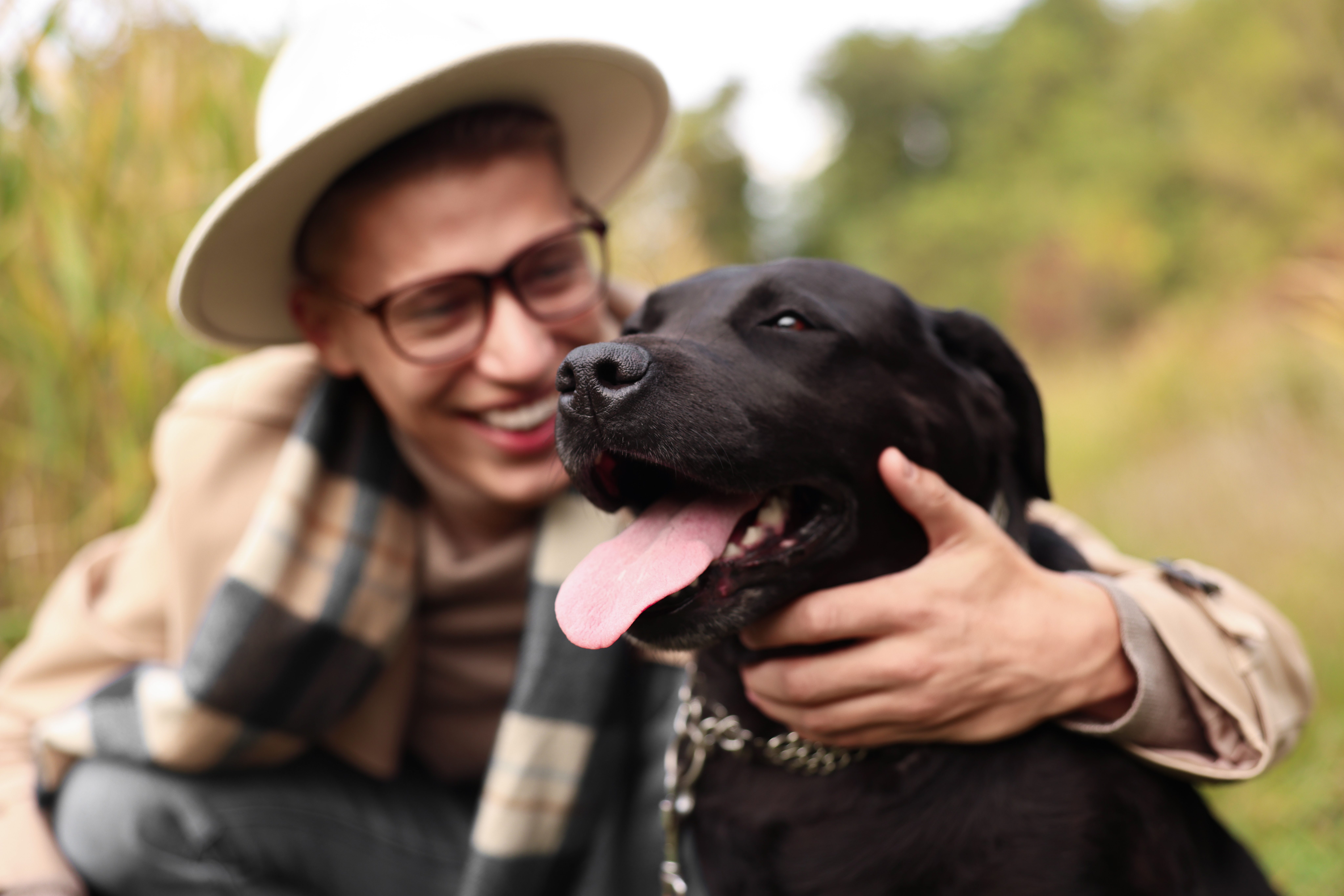 A man hugging his Labrador emotional support dog in Alabama. 