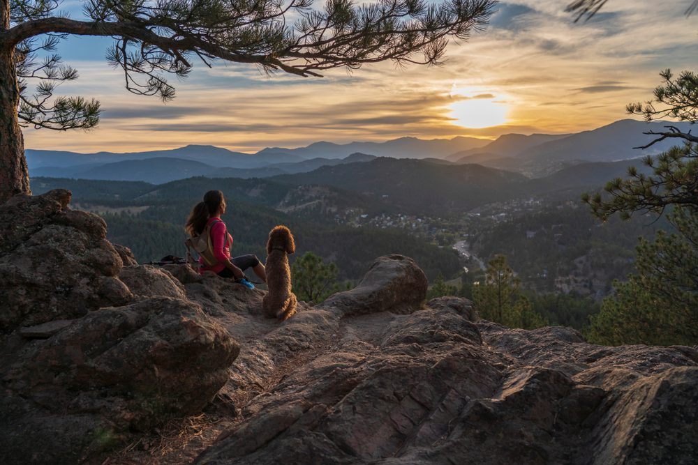 Woman and dog on sunset hike