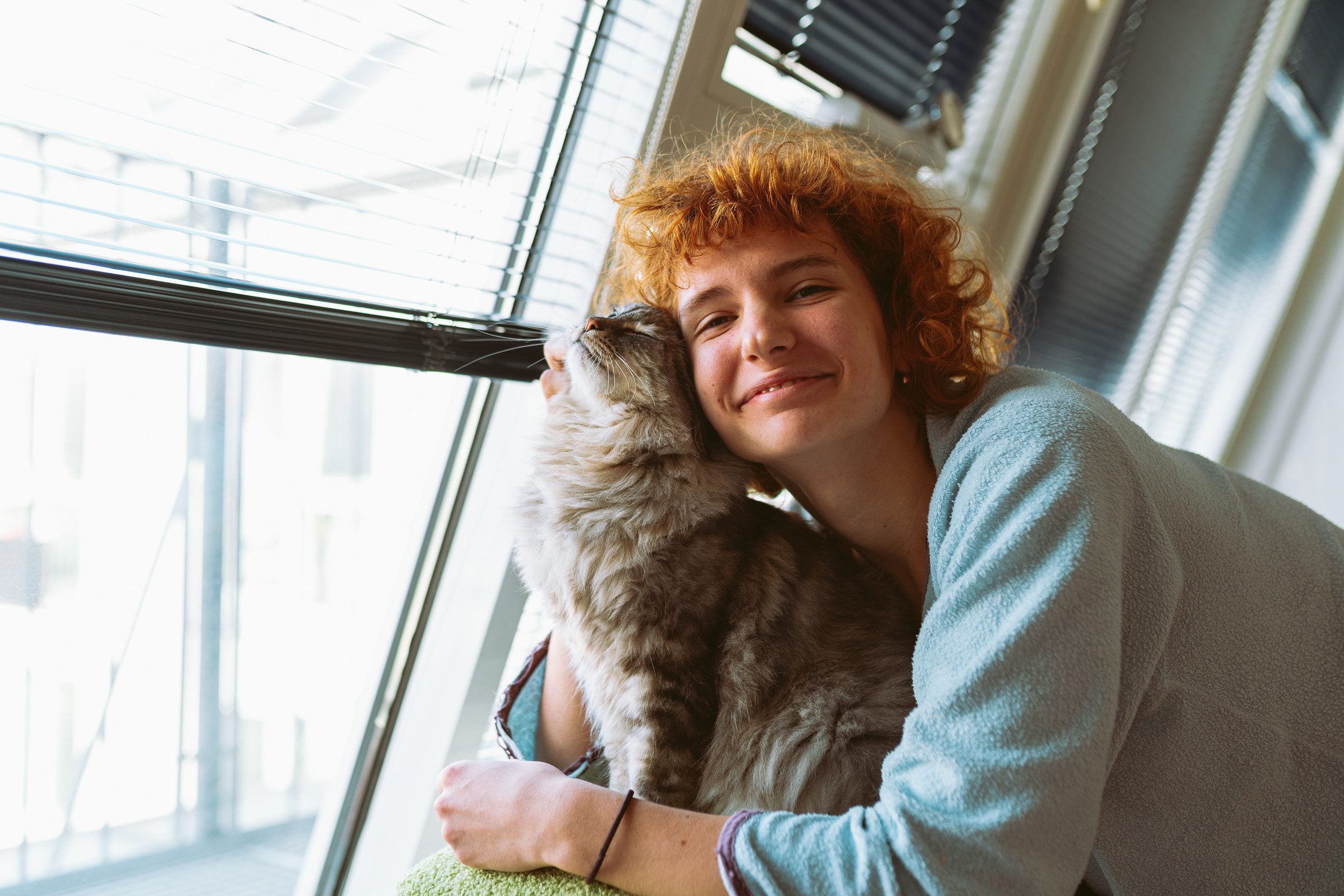 A happy girl hugging feline companion after learning how to get an ESA letter in Houston.