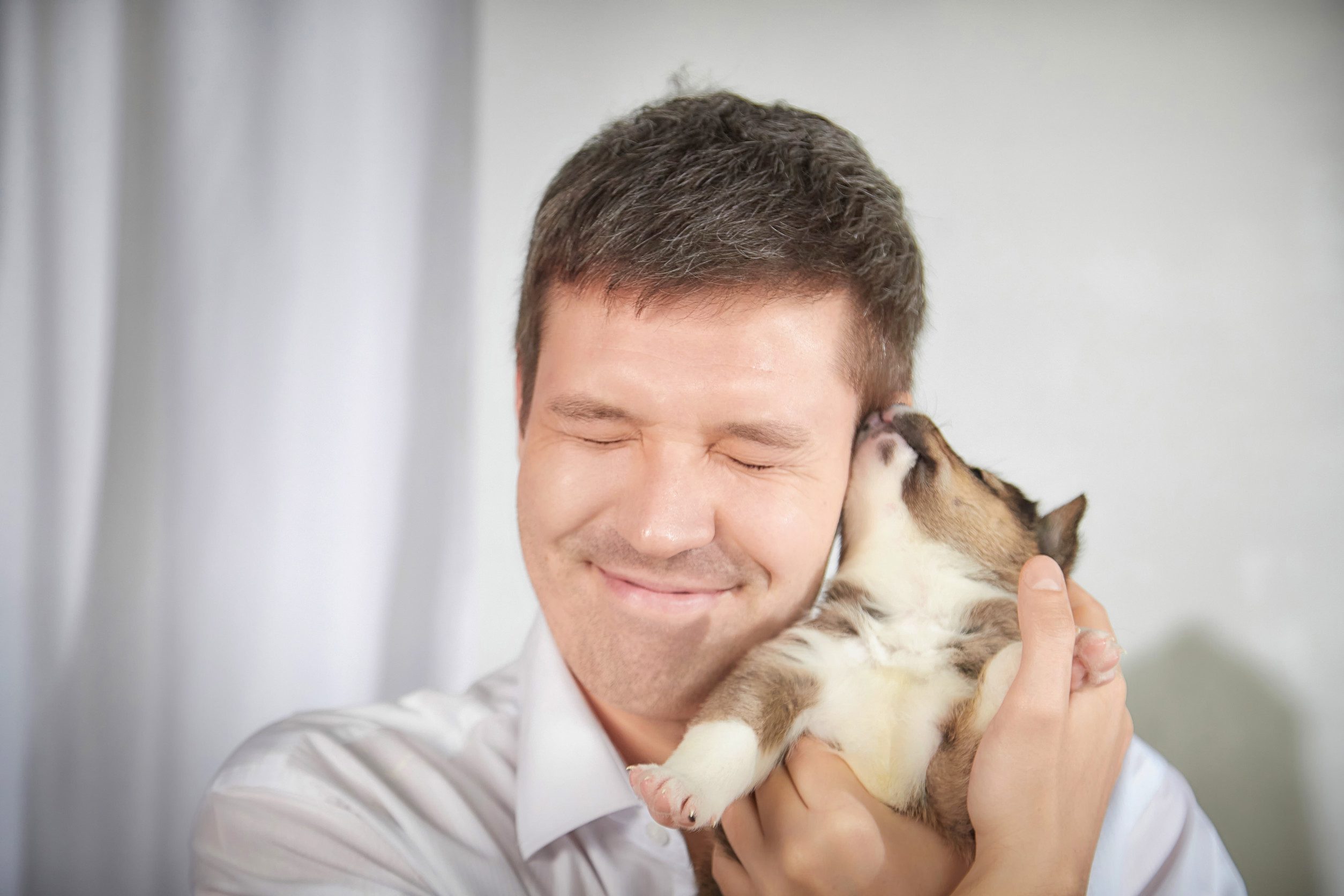 A happy man hugging a puppy after learning how to get an ESA letter in San Antonio.