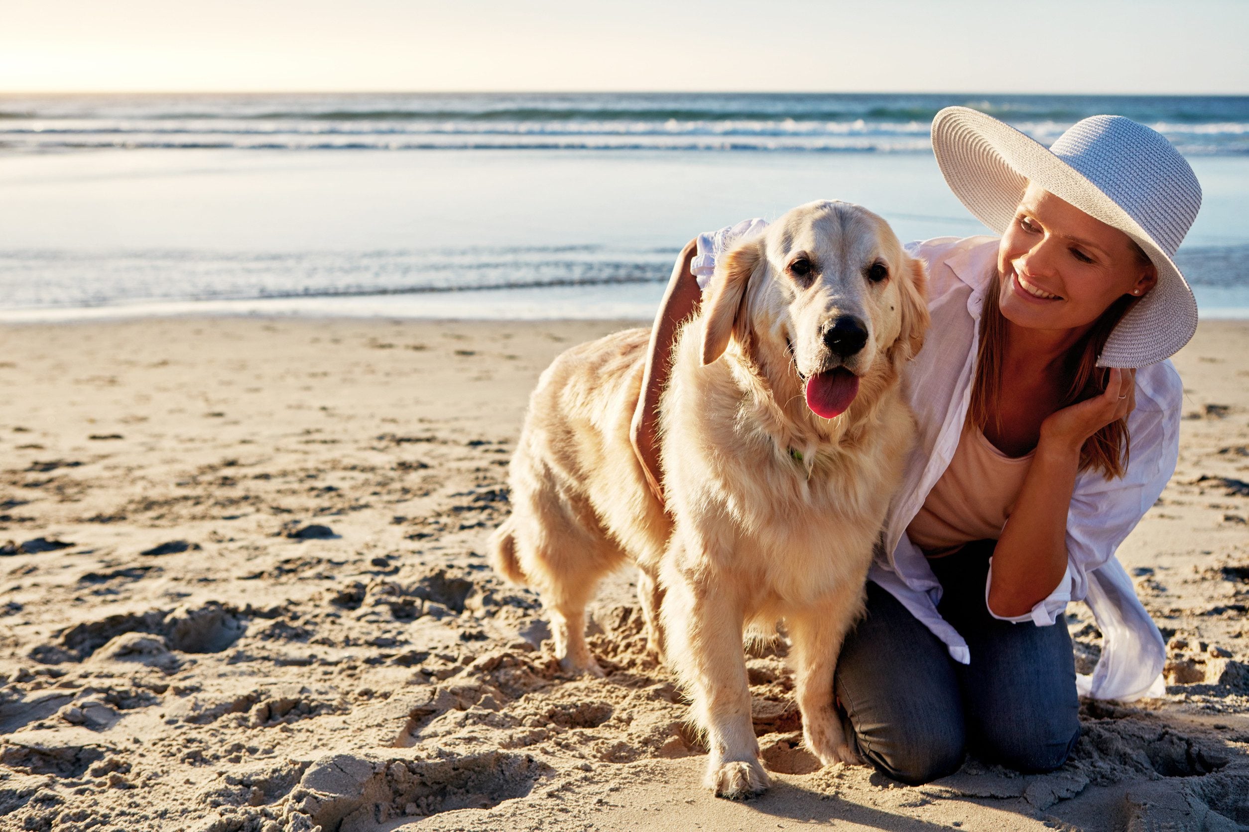 A woman spending time with her ESA on the beach in Long Beach, California.