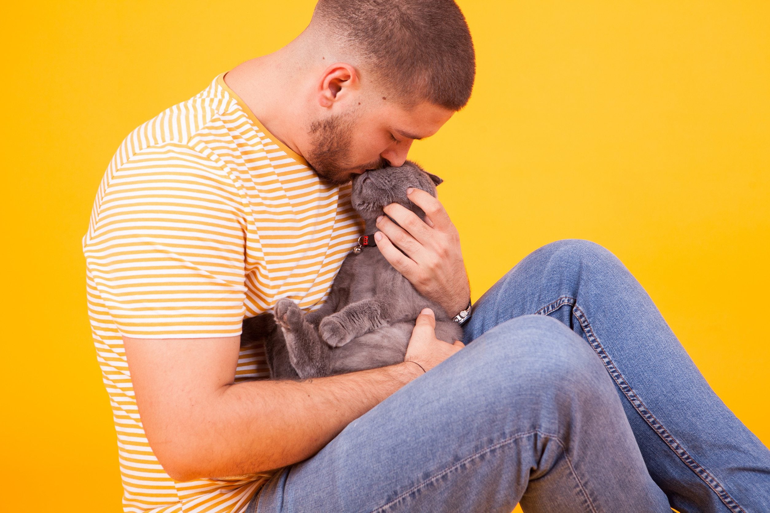 A man kissing his emotional support cat on the head in Las Vegas.