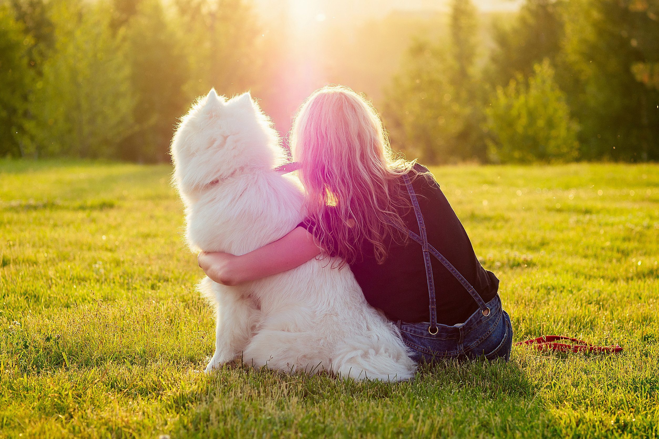 A woman sitting with her emotional support animal (ESA) in a park in Bellevue, NE.