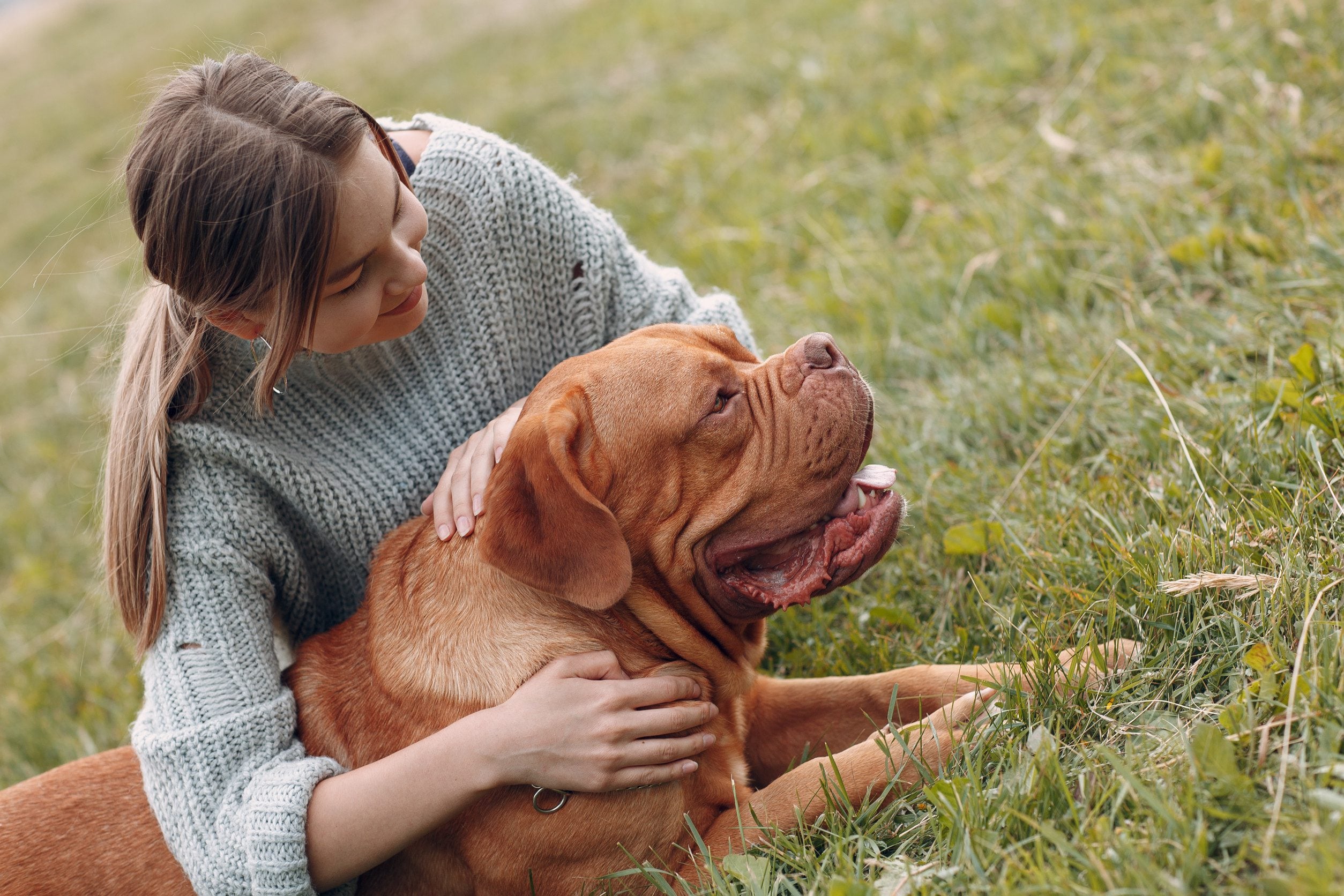 A woman sitting with her emotional support animal in a park in Hialeah, FL.