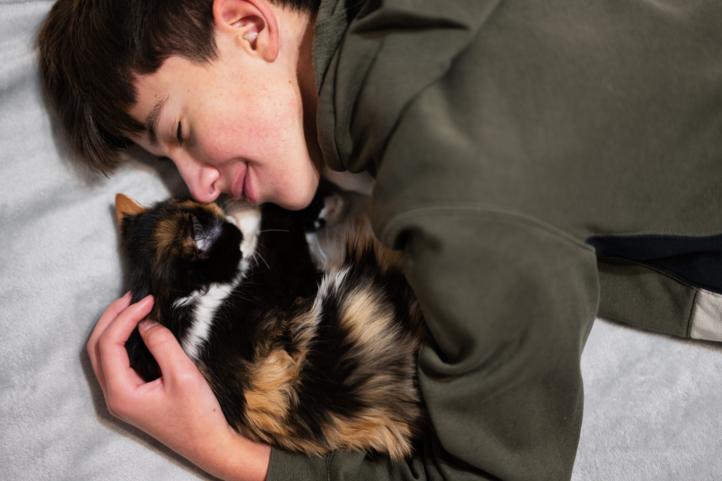 A teenager cuddling with an ESA in Naperville.