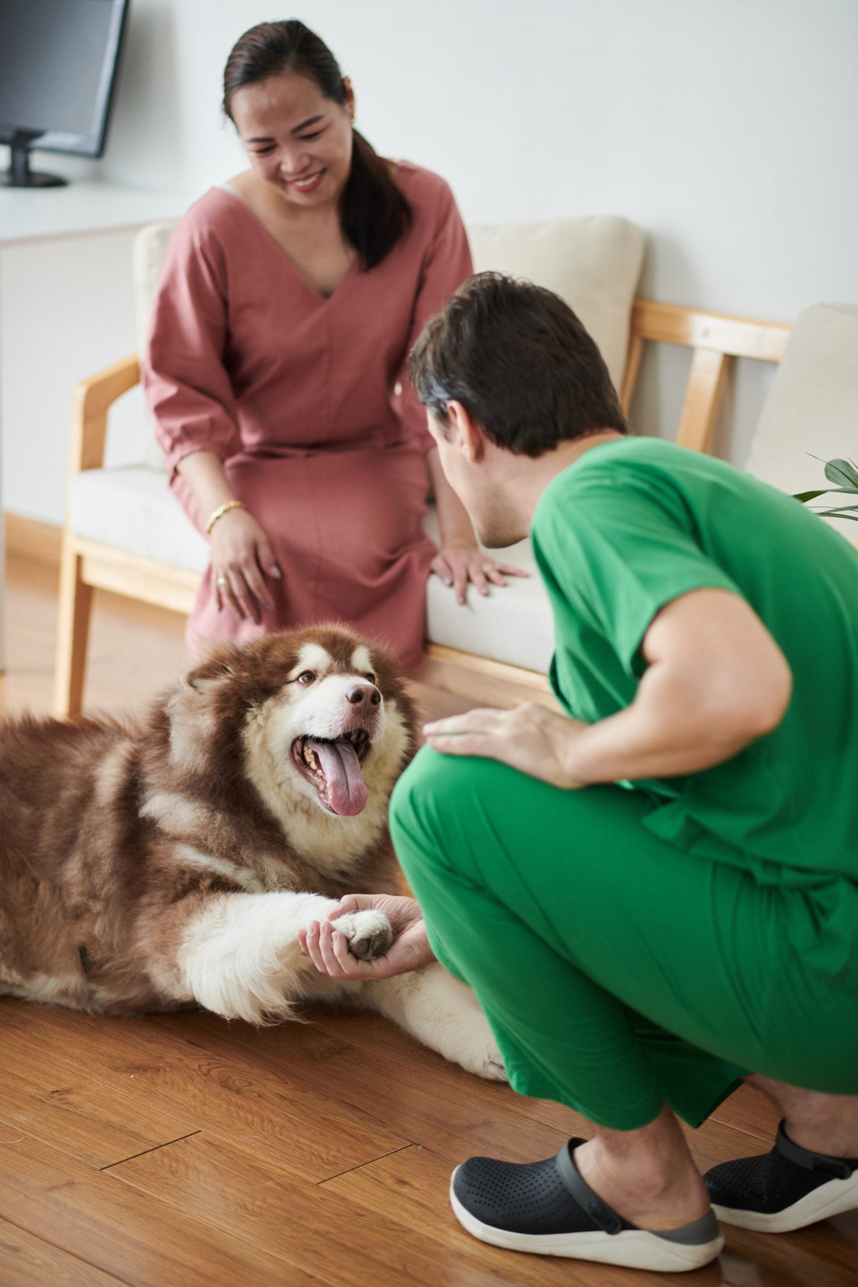 A happy couple in their Olathe apartment with an emotional support dog.