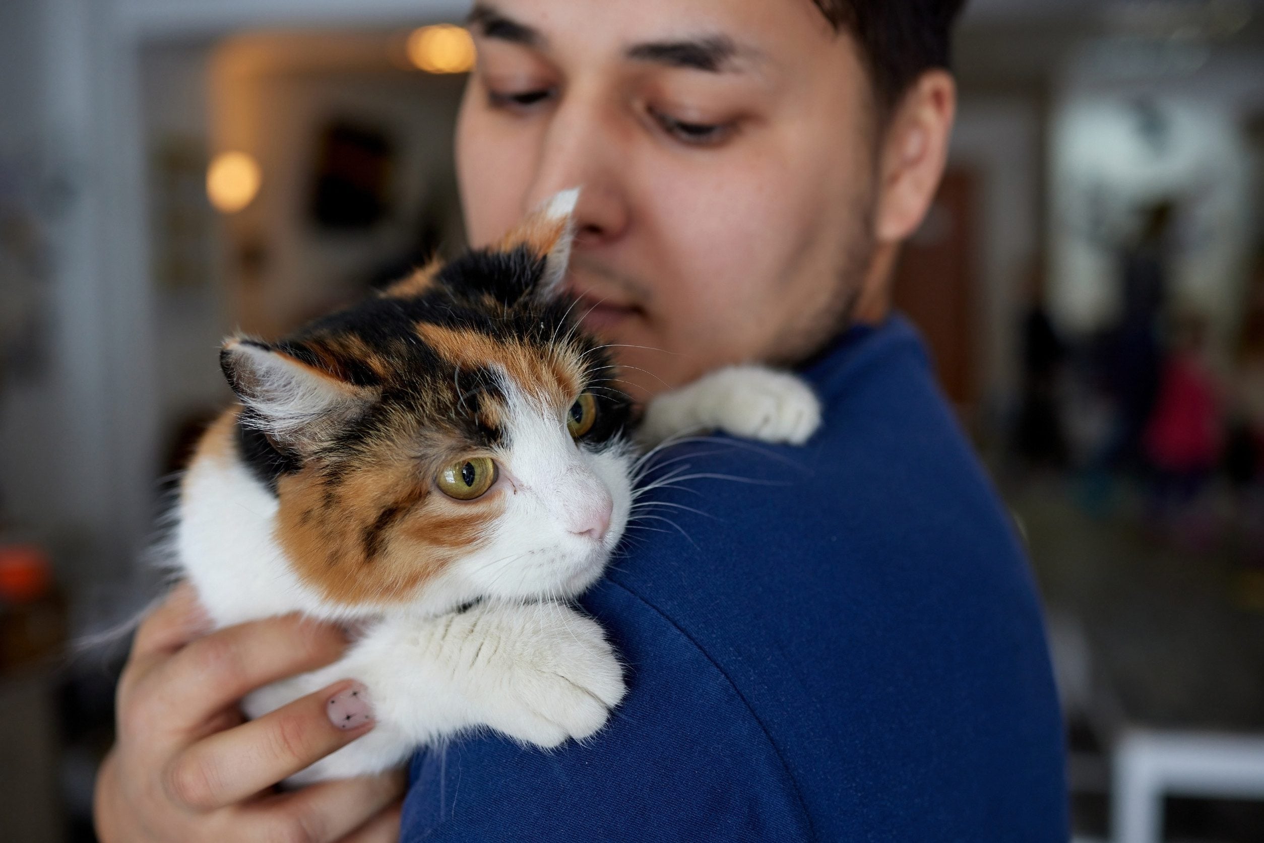A Billings, Montana resident holding their emotional support cat with an ESA letter.