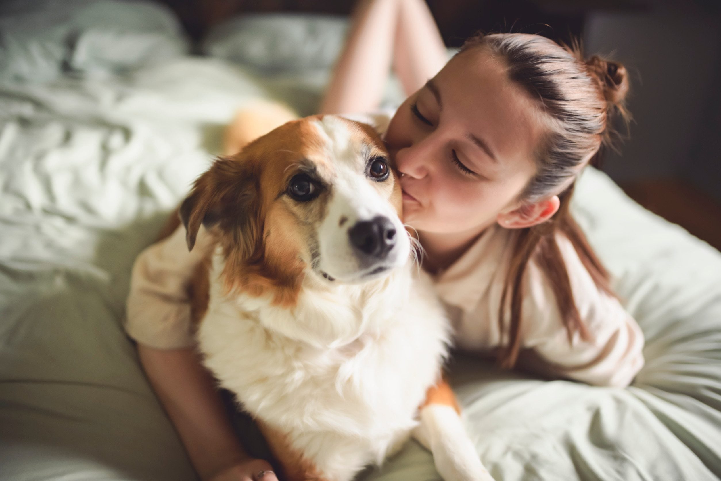 A young girl hugging her emotional support animal in Athens, GA.