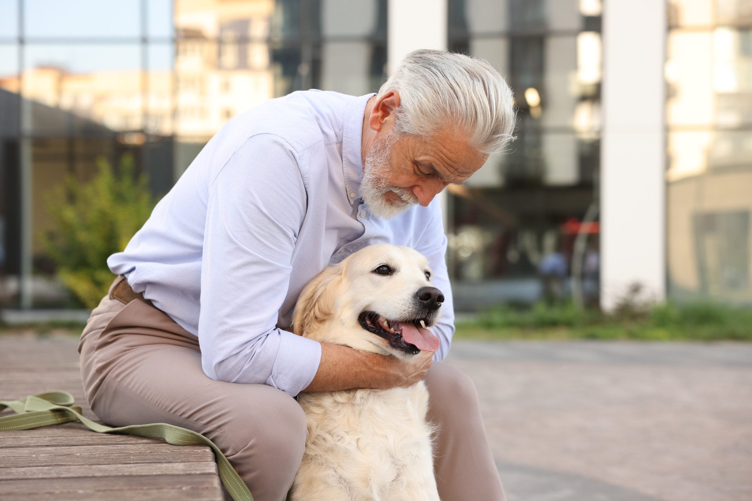 An elderly Bowling Green resident hugging an emotional support dog with a valid ESA letter in public.