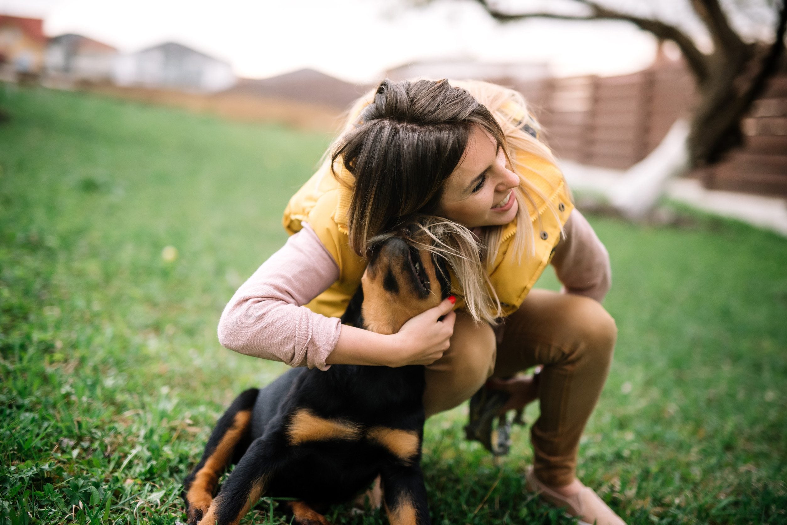 A woman playing with her emotional support animal in a park in Kahului, HI.