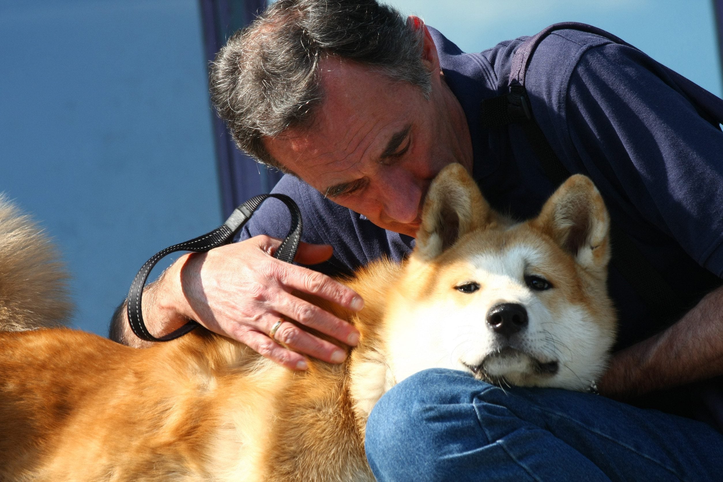 A man hugging his emotional support animal (ESA) dog in Lincoln, NE.