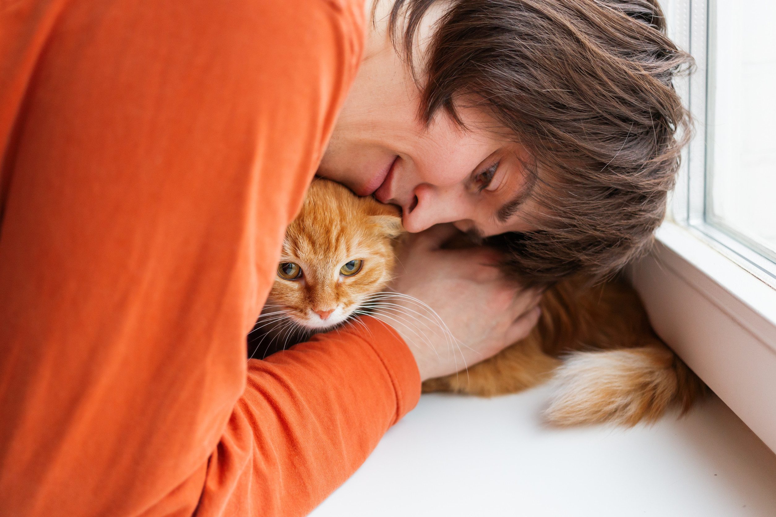 A happy owner hugging cat after learning how to get an ESA letter in Fort Worth.