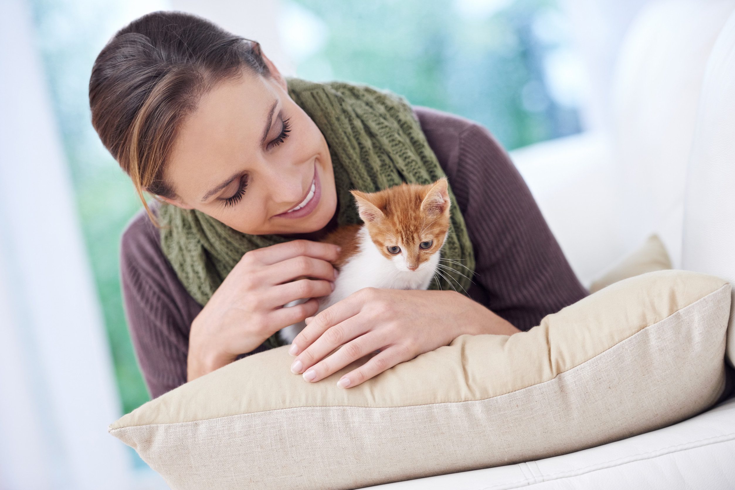 A young woman holding her support cat after learning how to get an ESA letter in Cincinnati.