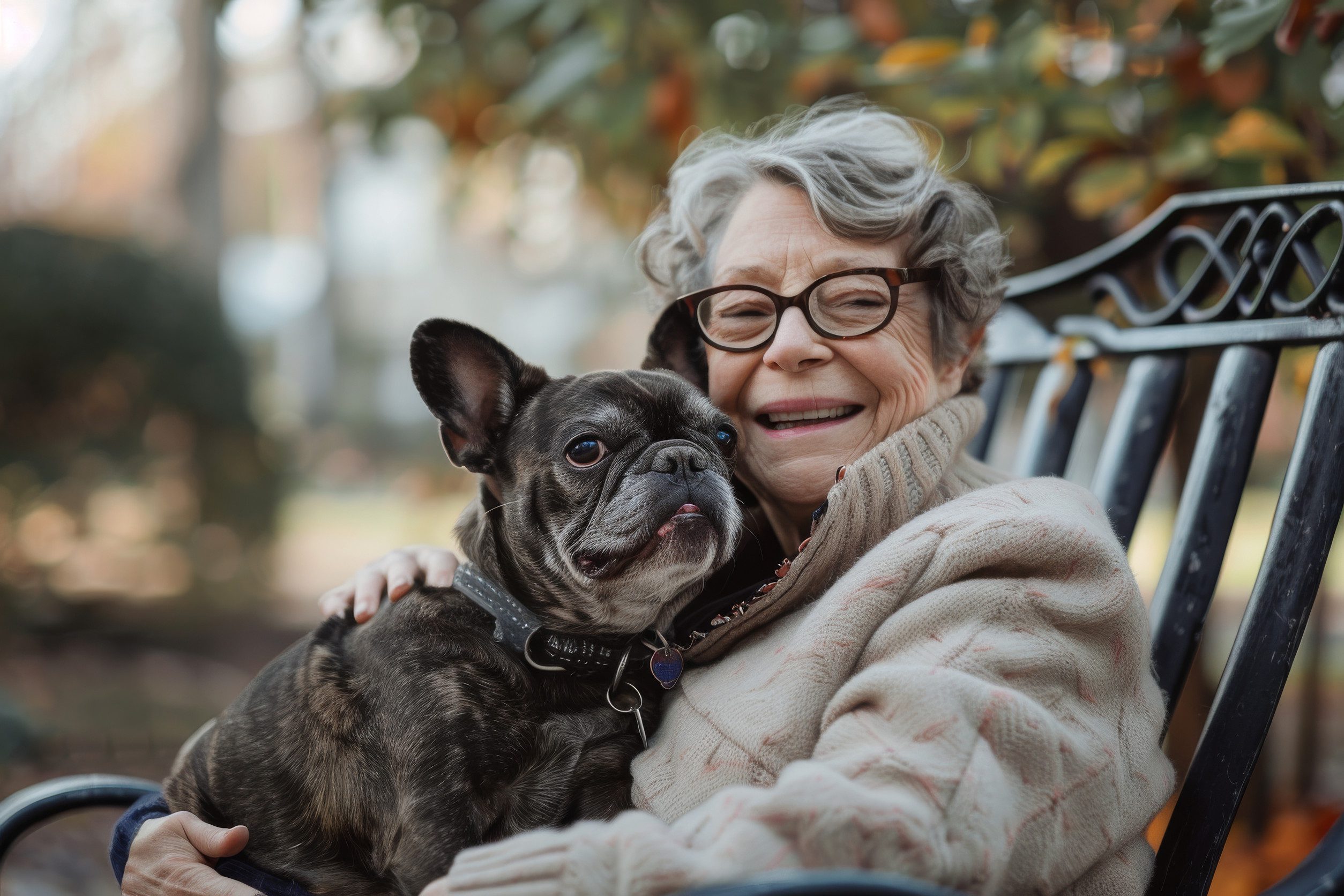 A woman sitting on a bench in a park in Eugene, OR, with her emotional support animal.