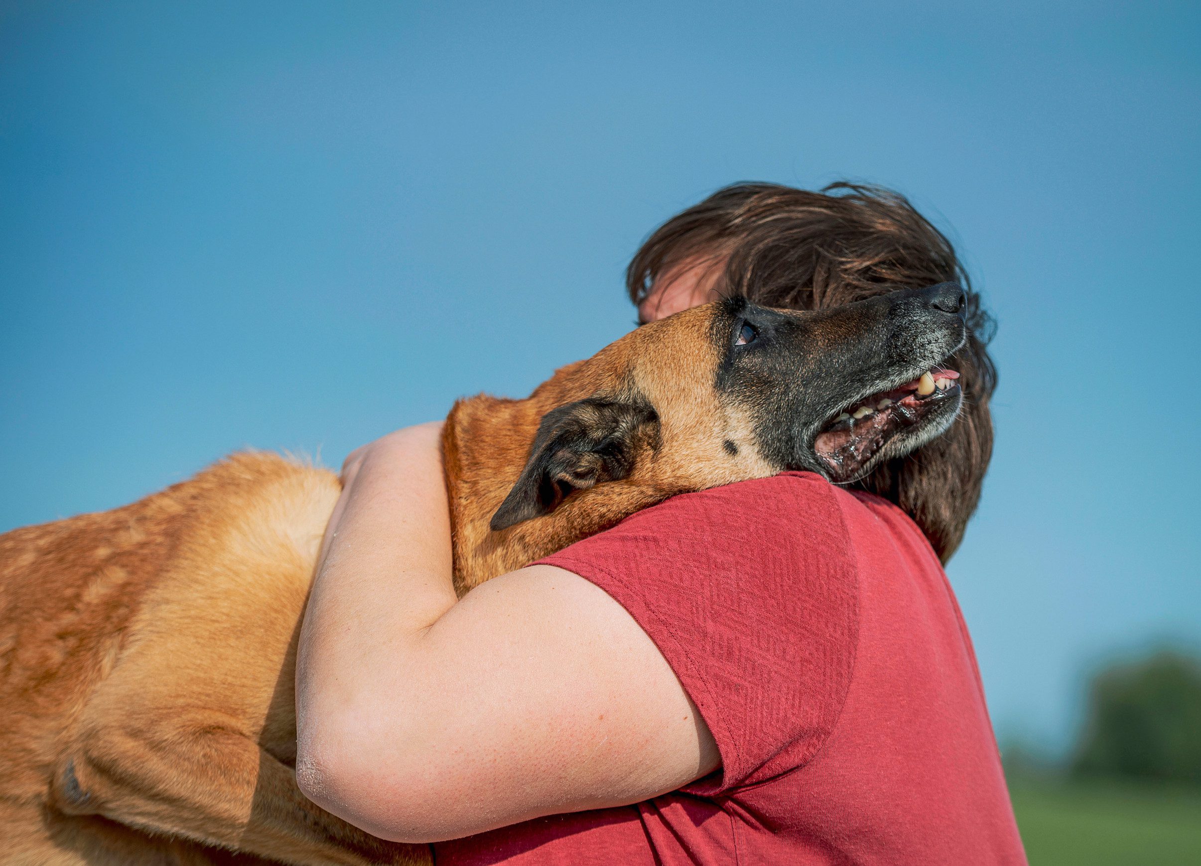 Woman hugging her emotional support dog after learning how to get an ESA in McKinney.