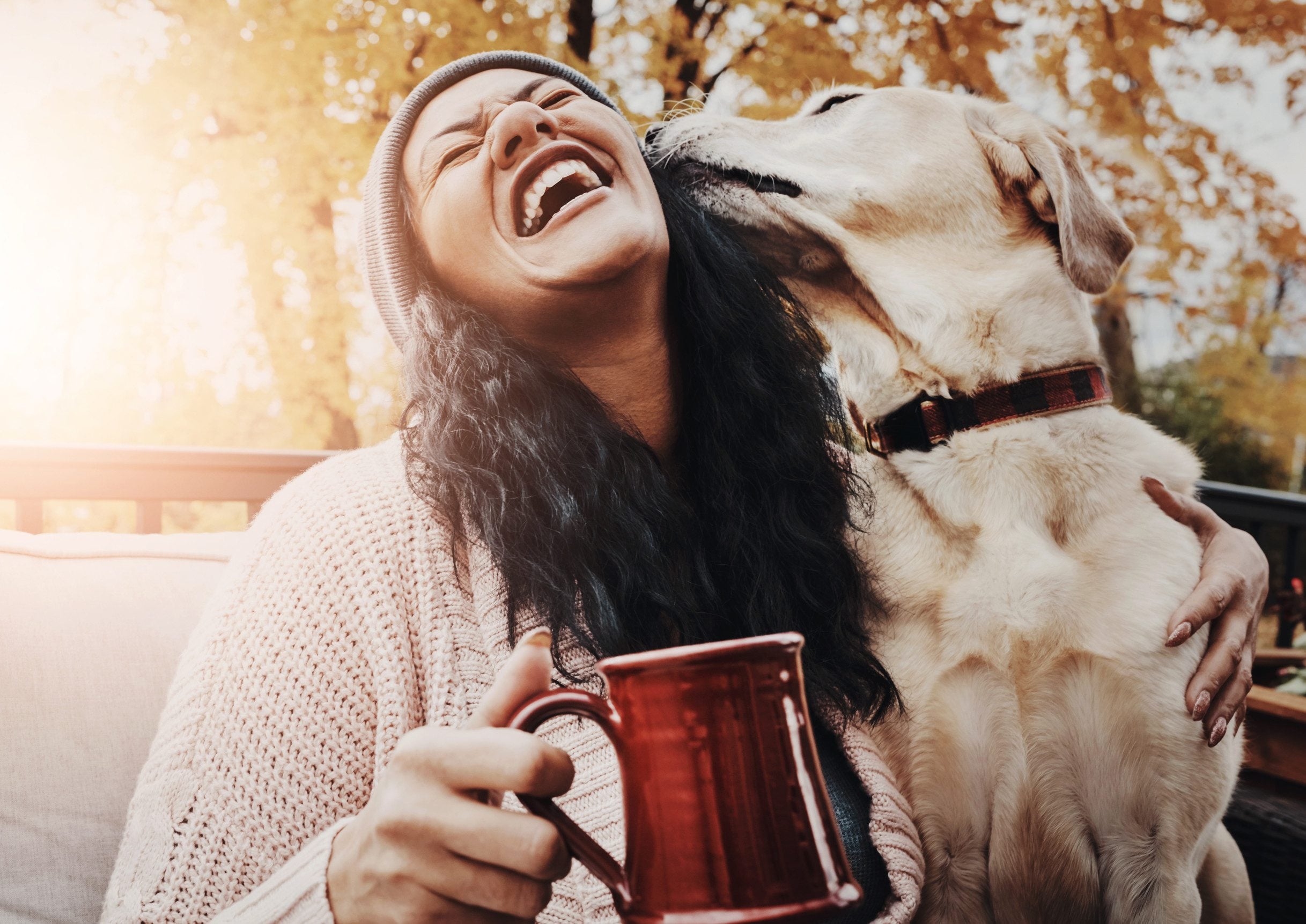 A woman enjoying her time with an ESA on a fall day after learning how to get an ESA letter in Pittsburgh for her dog.