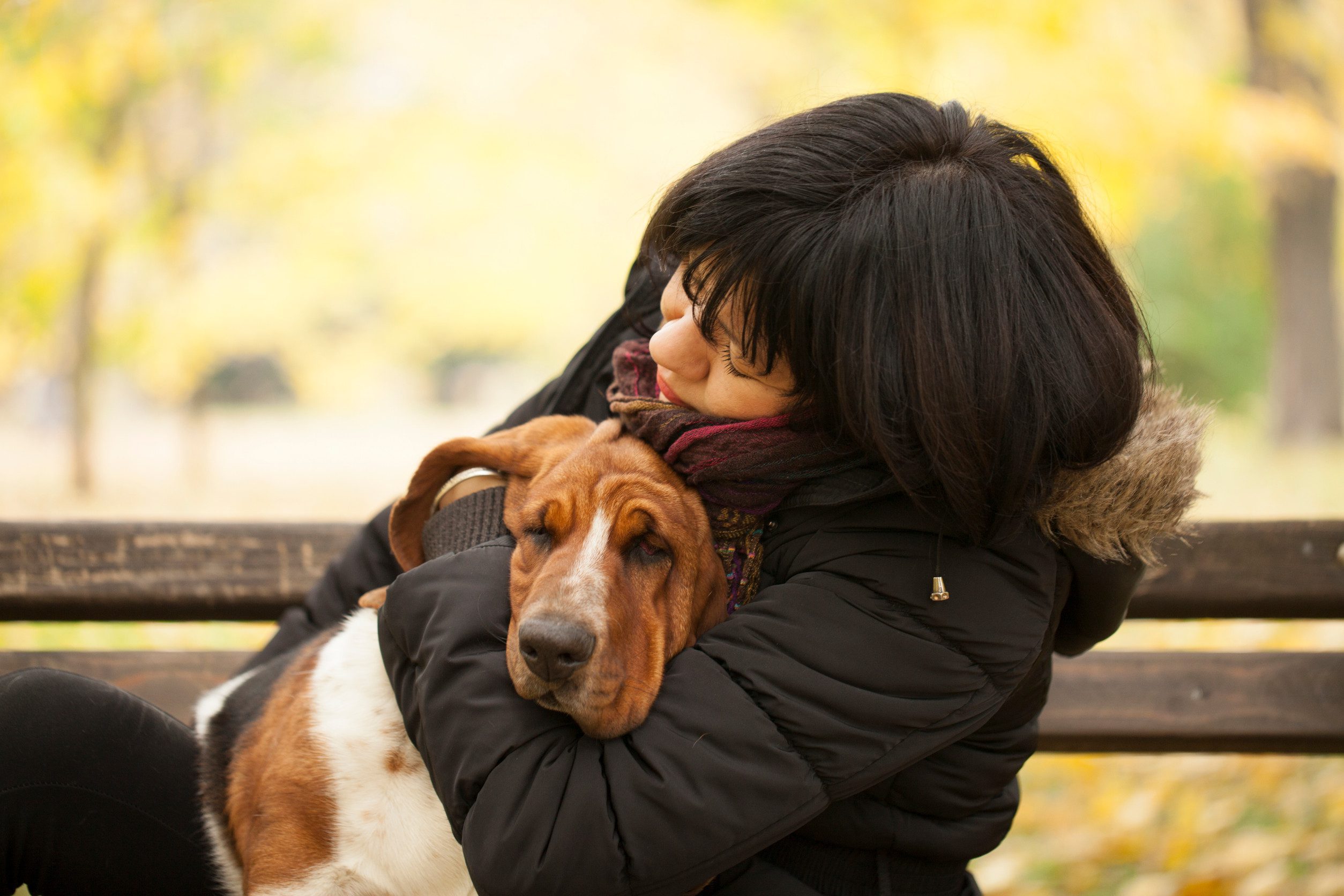 A woman hugging her emotional support animal in a park in Rio Rancho, NM.