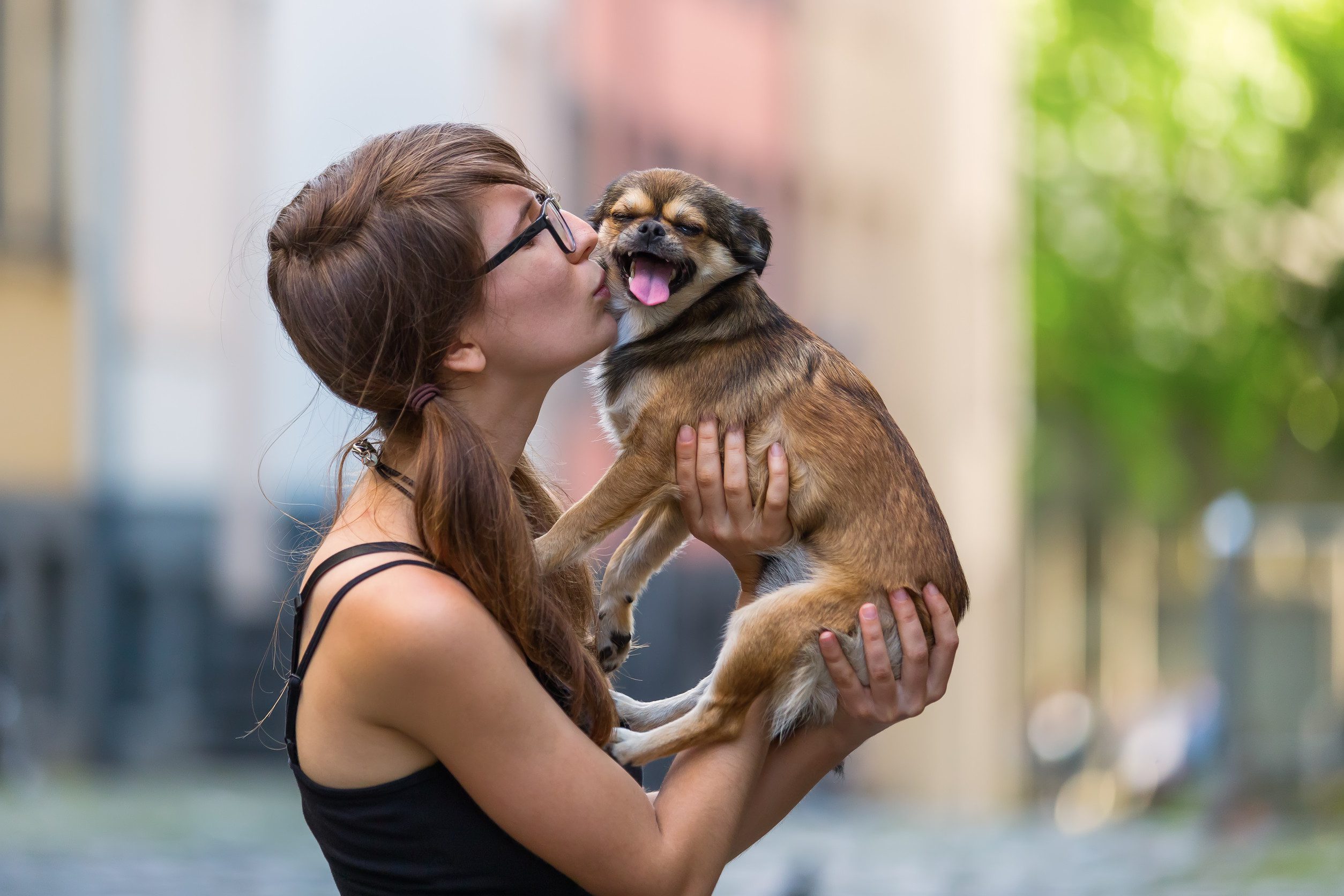 A woman kissing her emotional support animal (ESA) in Yonkers, NY.